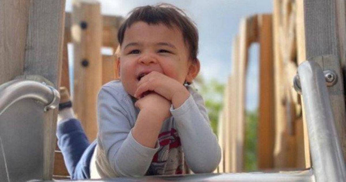 Elijah sitting at the top of a slide.